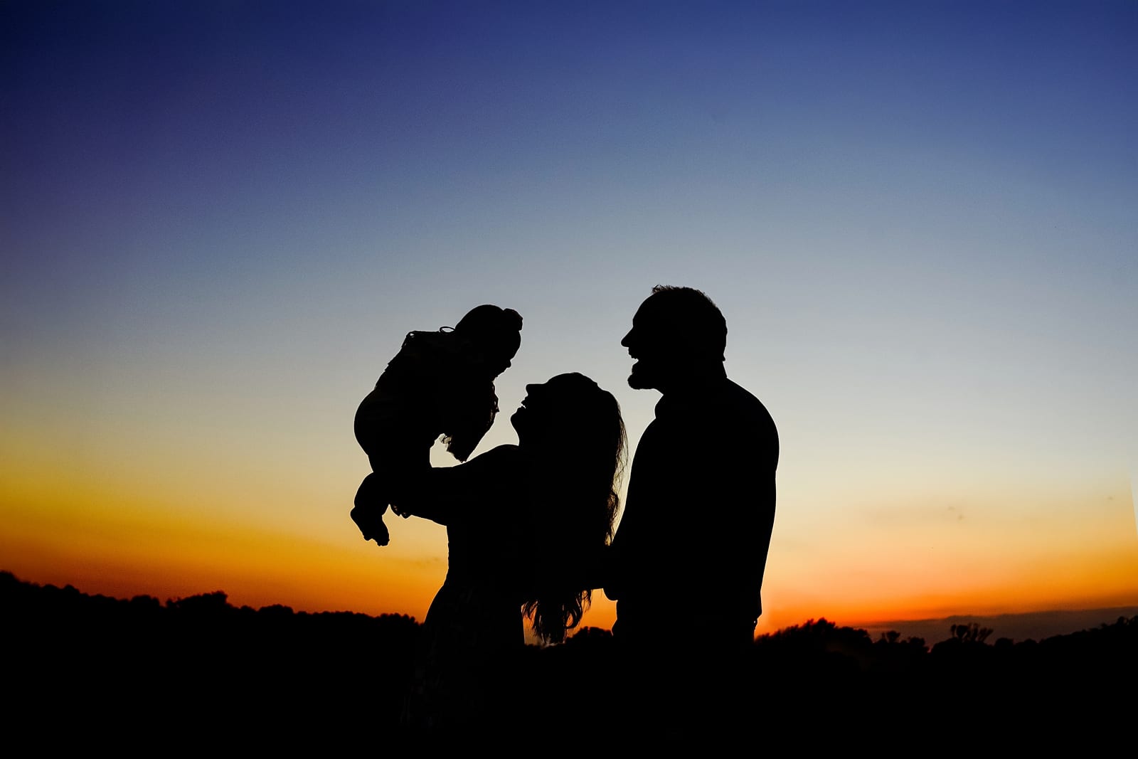 Silhouette of a family together at sunset