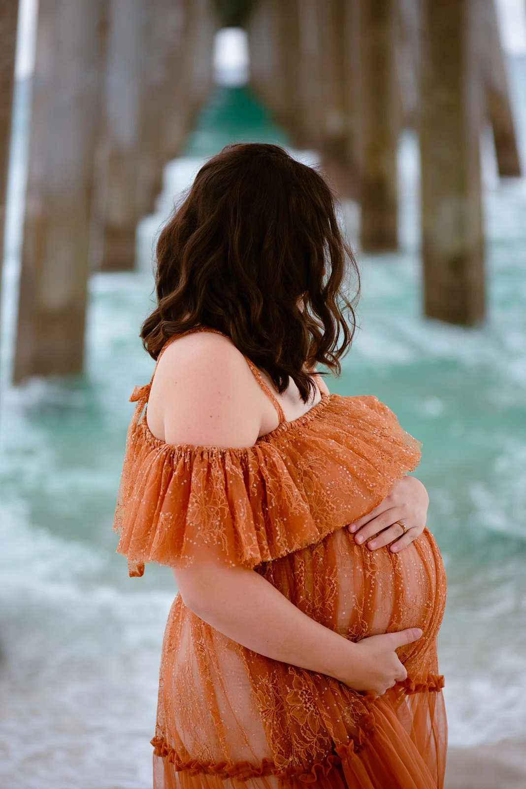 Expecting mother beneath a Pensacola Beach pier