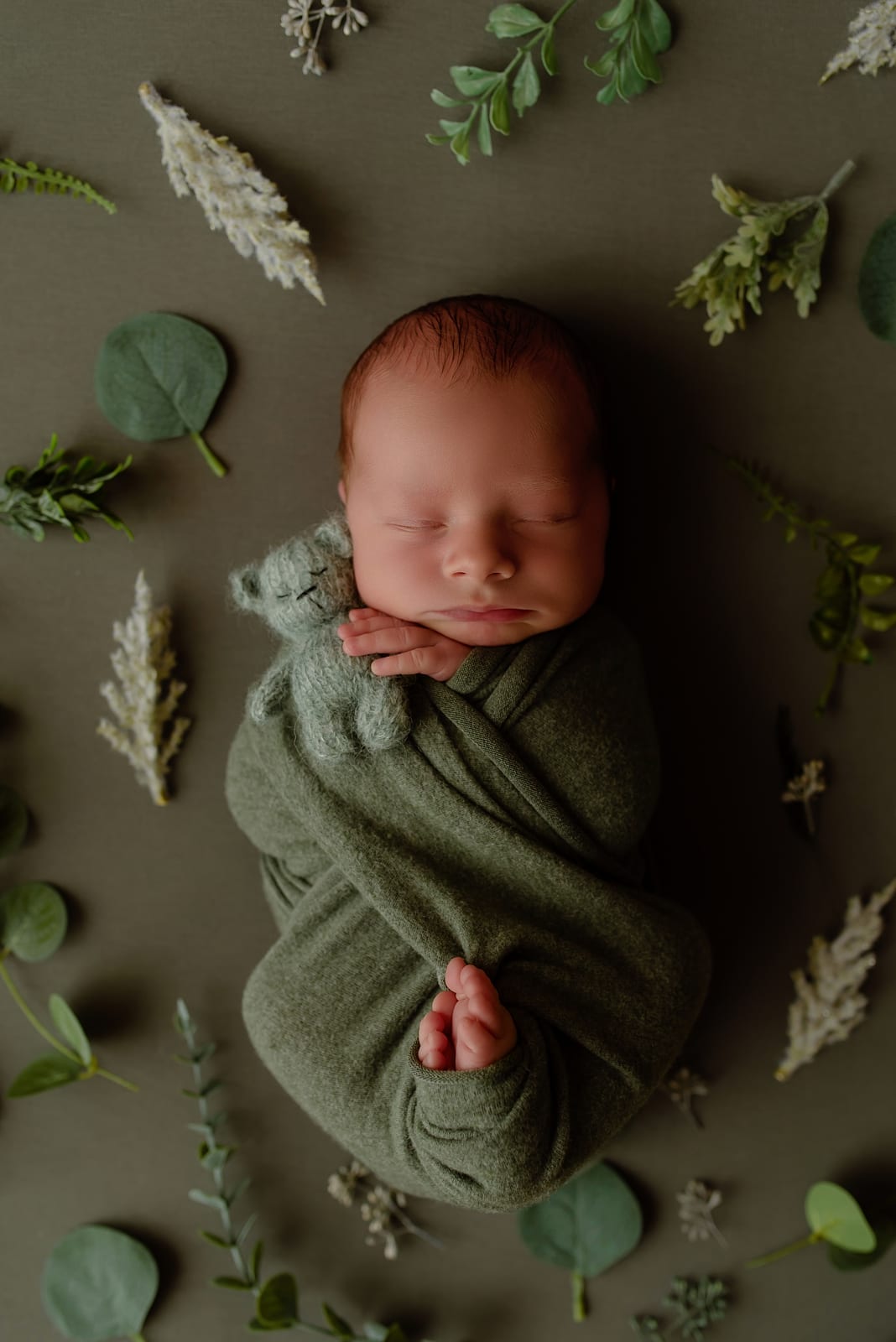Newborn wrapped in green